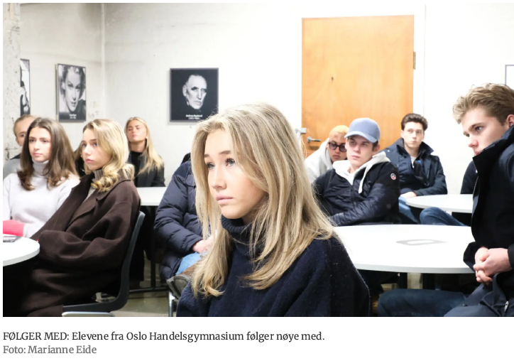 en gruppe mennesker som sitter ved bord